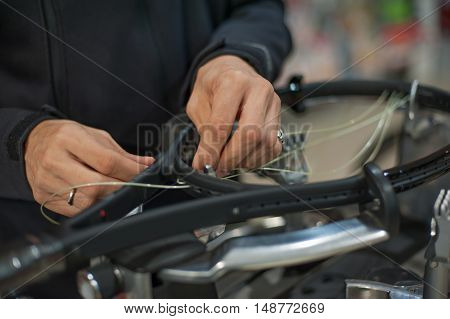 Close Up Of Tennis Stringer Hands Doing Racket Stringing