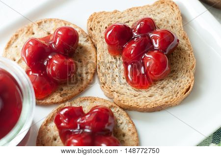 cherry topping dessert on cracker bread white plate