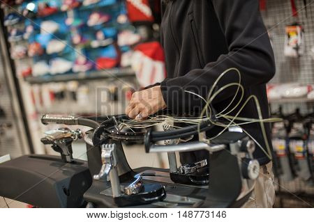 Close Up Of Tennis Stringer Hands Doing Racket Stringing