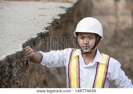 Engineer checking damaged road asphalt concrete design