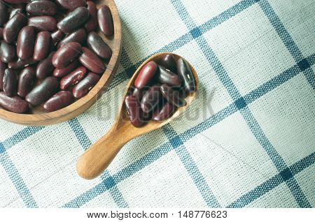 red bean in spoon on table tablecloth
