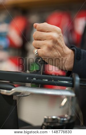 Tennis Stringer Holding Awl And Doing Racket Stringing