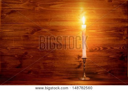 Burning Old Candle With Vintage Brass Candlestick On Wooden Background, Natural Light, Close Up