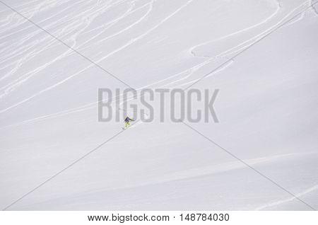 Freeride off-piste snowboard track in fresh white snow and freerider snowboarder moving down in snow powder. extreme sport concept.