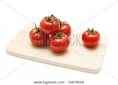 tomatoes on wooden board
