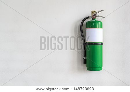 Green Tank fire mounted on a concrete wall.