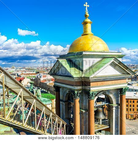 SAINT PETERSBURG RUSSIA - APRIL 25 2015: The tourists on the covered staircase climb to the rooftop of the St Isaac's Cathedral overlooking beautiful bell towers and city roofs on April 25 in Saint Petersburg.