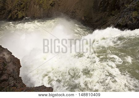 A turbulent maelstrom of water churns amidst great spray as the Yellowstone River falls one hundred feet over Upper Yellowstone Falls.