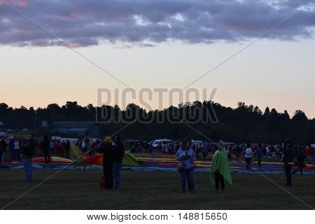 QUEENSBURY, NY - SEP 24: Balloon launch at dawn at the 2016 Adirondack Hot Air Balloon Festival held from Sep 22-25. Thousands of people attended the festival which is the largest of its kind on the East coast.
