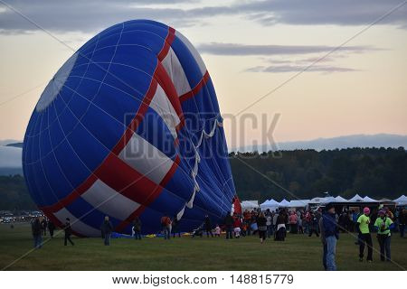 QUEENSBURY, NY - SEP 24: Balloon launch at dawn at the 2016 Adirondack Hot Air Balloon Festival held from Sep 22-25. Thousands of people attended the festival which is the largest of its kind on the East coast.