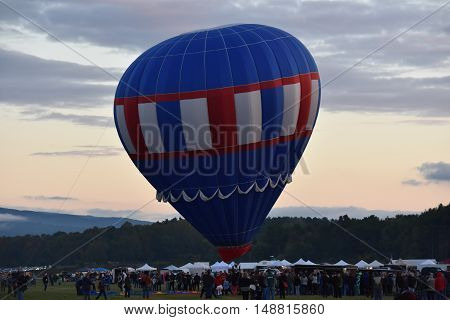 QUEENSBURY, NY - SEP 24: Balloon launch at dawn at the 2016 Adirondack Hot Air Balloon Festival held from Sep 22-25. Thousands of people attended the festival which is the largest of its kind on the East coast.