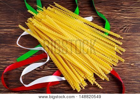 Uncooked Authenric Tripoline spaghetti pasta with italian flag style ribbons.