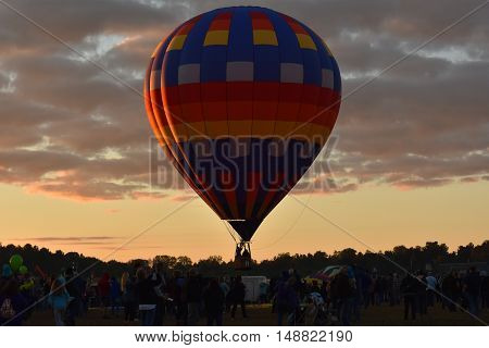QUEENSBURY, NY - SEP 24: Balloon launch at dawn at the 2016 Adirondack Hot Air Balloon Festival held from Sep 22-25. Thousands of people attended the festival which is the largest of its kind on the East coast.