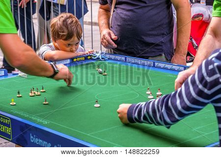 Bologna Italy 18 September 2016: A child focusing on a Subbuteo game