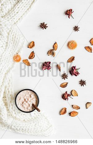 Autumn composition. Hot chocolate knitted blanket dried flowers autumn leaves. Flat lay top view