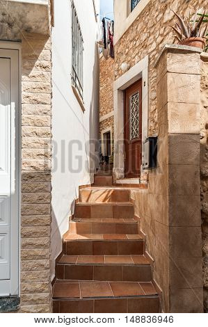 Stairs between traditional greek houses at narrow street of Sitia town on Crete island, Greece