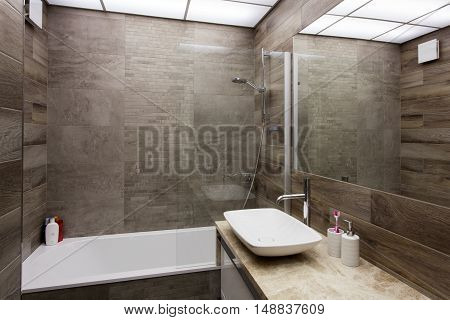 Modern interior of a bathroom in brown tones