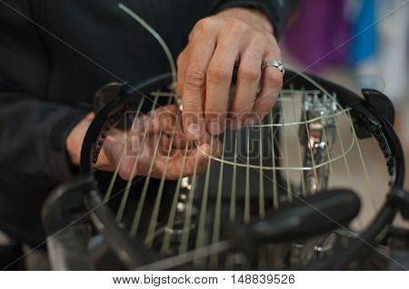Close Up Of Tennis Stringer Hands Doing Racket Stringing