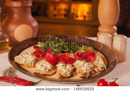 Toast with red fish and greens on a plate