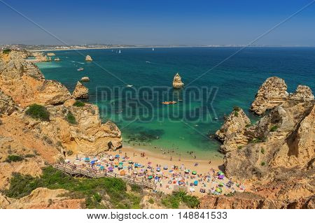 Camilo Beach, Lagos in the Algarve. Tourists sunbathe on the sand.