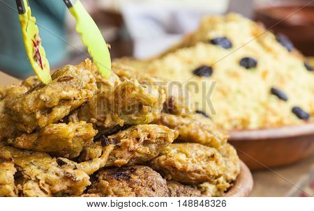 Vegetables fried rolls in batter also called Mshat Zahra and couscous. Moroccan recipes