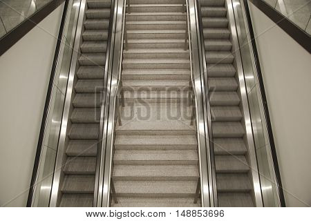 Empty escalator from above, one of them slightly motion blurred