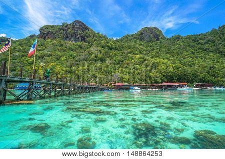 Semporna,Sabah-Sep 10,2016:Wooden jetty with Sabah & Malaysia flag at Bohey Dulang tropical island,Semporna,Sabah.Bohey Dulang Island is one of the most popular islands in Tun Sakaran Marine Park.