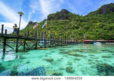 Semporna,Sabah-Sep 10,2016:Wooden jetty with Sabah & Malaysia flag at Bohey Dulang tropical island,Semporna,Sabah.Bohey Dulang Island is one of the most popular islands in Tun Sakaran Marine Park.