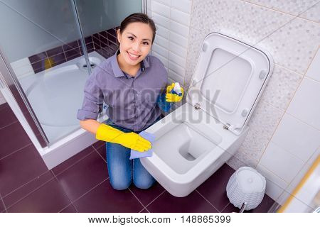 Young beautiful asian woman housekeeping in the bathroom