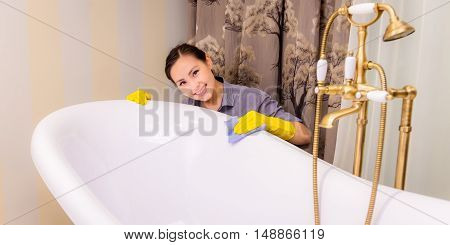 Young beautiful asian woman housekeeping in the bathroom