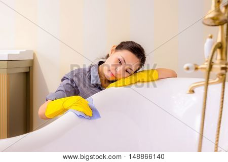 Young beautiful asian woman housekeeping in the bathroom