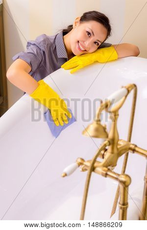 Young beautiful asian woman housekeeping in the bathroom
