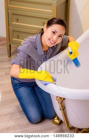 Young beautiful asian woman housekeeping in the bathroom
