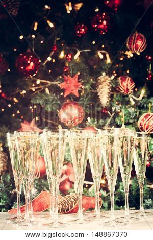 Glasses Of Champagne With Christmas Tree Background. Many Glasses For Party. Holiday Season Backgrou