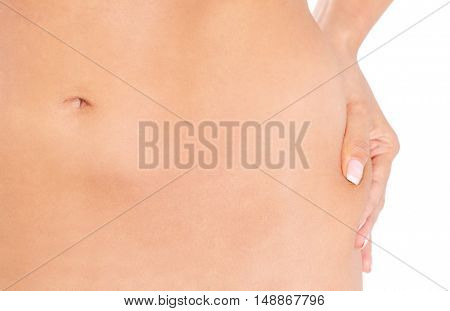 Slim woman pinch skin on hip