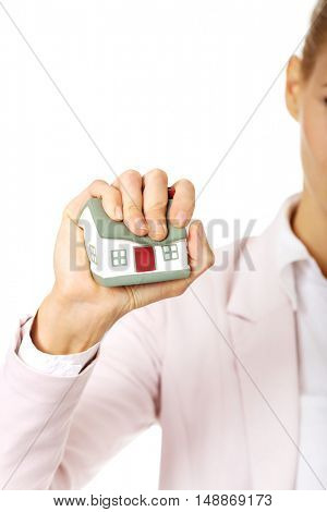 Aggresive business woman crushing small house