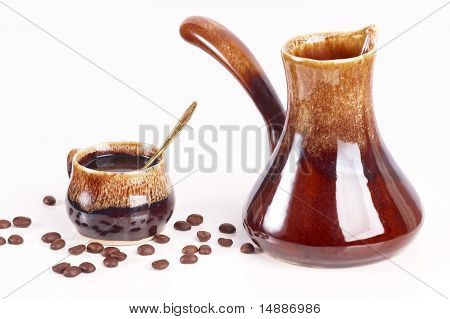 Cup of coffee with a coffee pot
