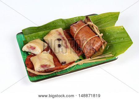 Streamed sticky rice and black bean in banana leaf as "Khao Tom Mad" in Thai is popular Thai dessert.