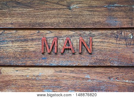 MAN word on wooden table in vintage style.