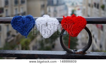 View through France flag tricolor at Montmartre streets
