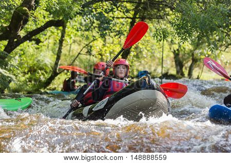 BALA WALES UNITED KINGDOM SEPTEMBER 17 2016: White water kayakers at the National White Water Centre canoeing through rapids on the River Tryweryn