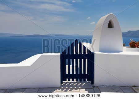 dark blue gates against volcano caldera and Aegan sea, beautiful details of Santorini island, Greece