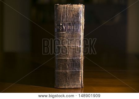 Old Bible Resting on a Desk in a Library