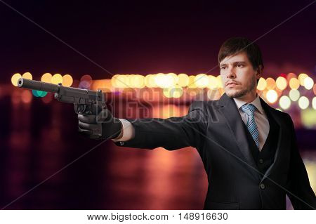 Hitman Or Secret Agent Is Aiming With Pistol At Night.