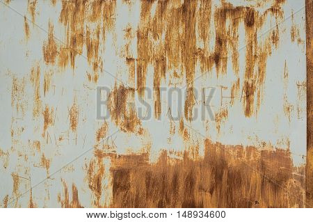 Rusty steel garage door. Strips of rusting as the strokes of paint on a gray metal background