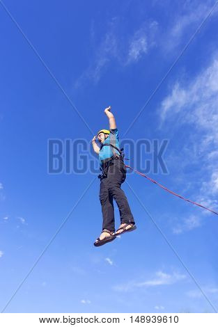 The first jump off the cliff with a safety rope.