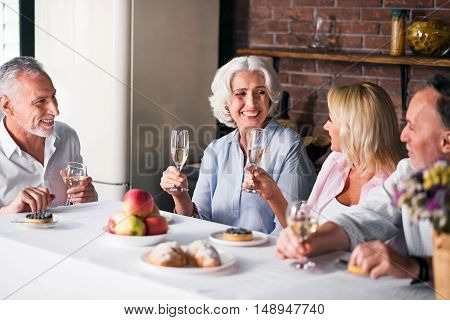 Family time. Cosy dinner party at neat household with wine and dessets