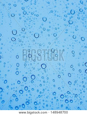 Close-up of water drops on glass surface as background