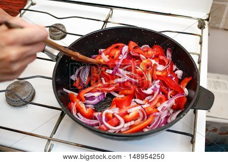 Fresh vegetables, peppers and onions in a frying pan, cooking food at home soviet union kitchen