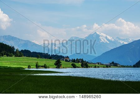 Beautiful view of the lake Muta (Haidersee) and Ortler peak, located near the village St. Valentin, Alps, Italy, Europe.